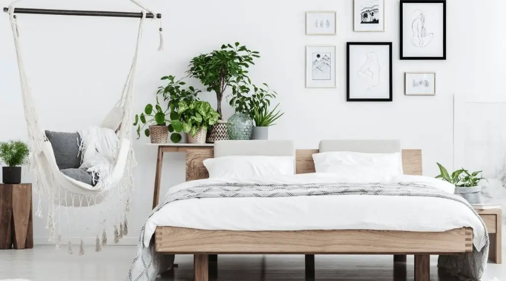 relaxing bedroom sanctuary plants hammock and platform bed