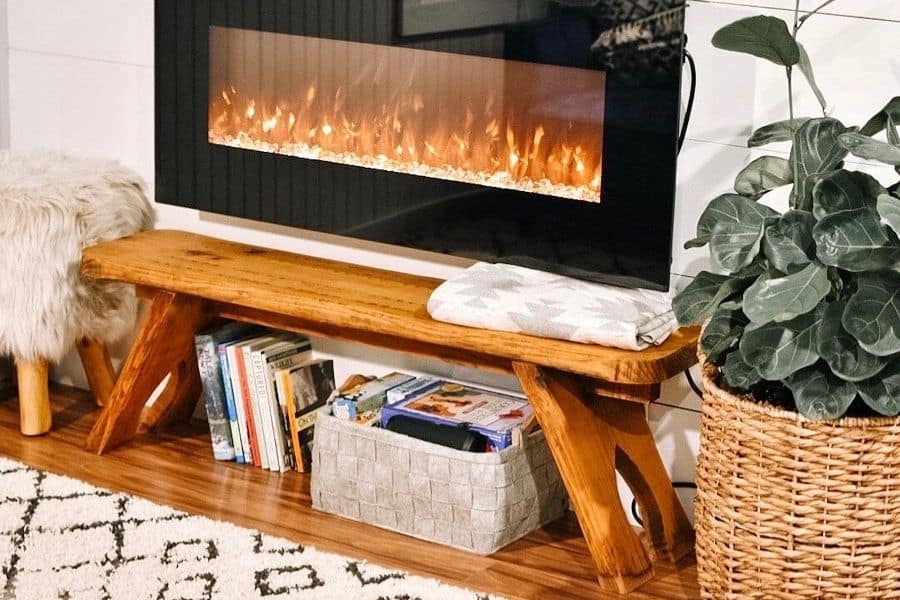 aesthetic plant beside built in fireplace with white dotted and stripped shag rug infront of fireplace