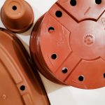 group of plastic and terracotta plant pots with drain holes
